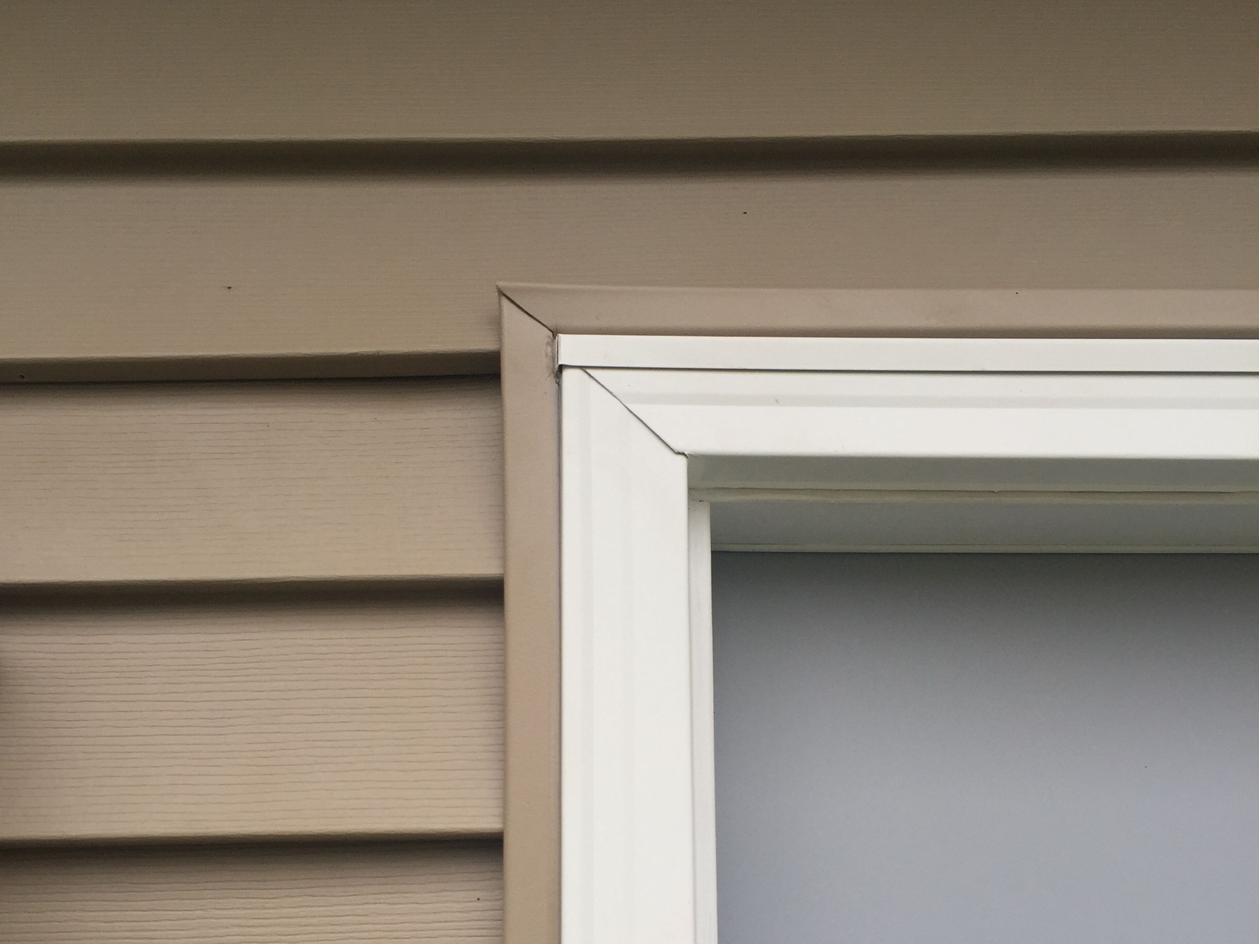 Trim detail around a replacement window on a re-sided home