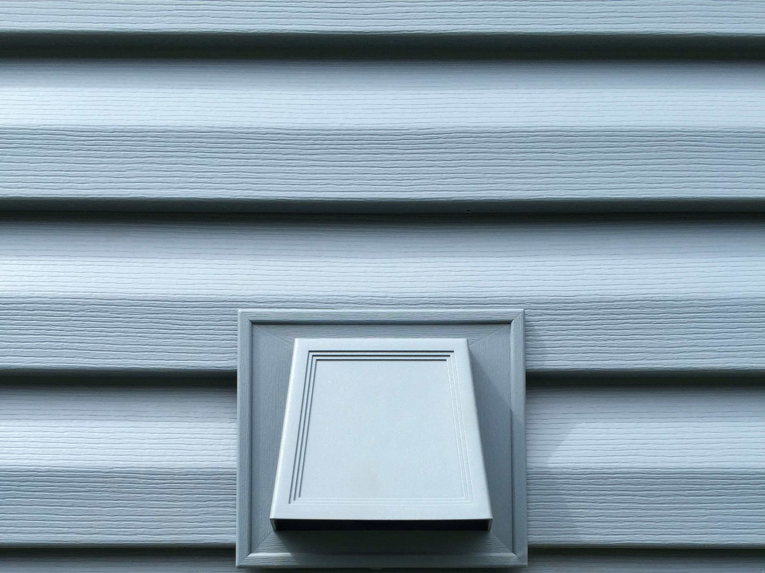 Wall vent set into new siding panels