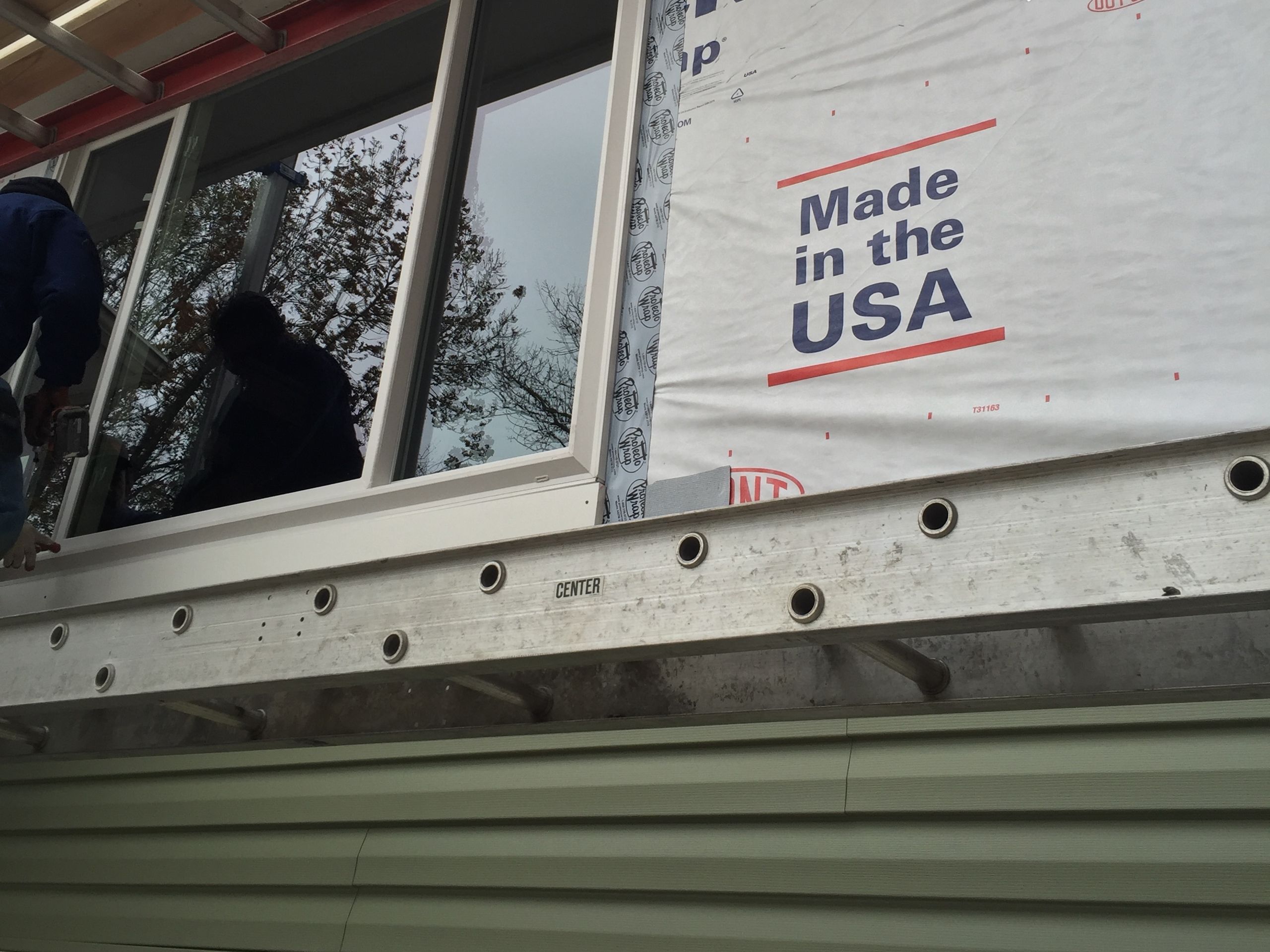 Installers setting a new window from inside the home