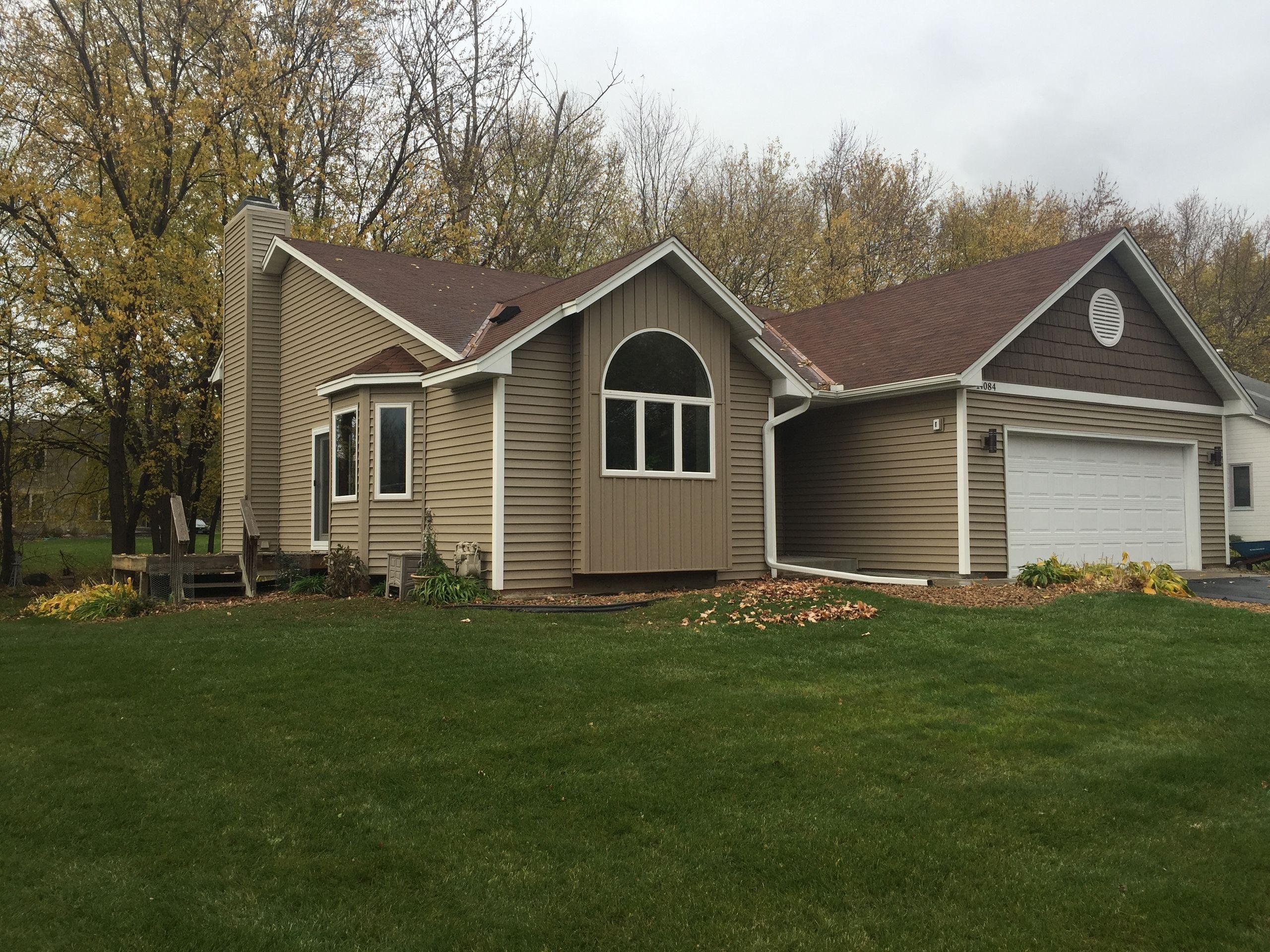 Rambler re-sided in tan vinyl with new windows