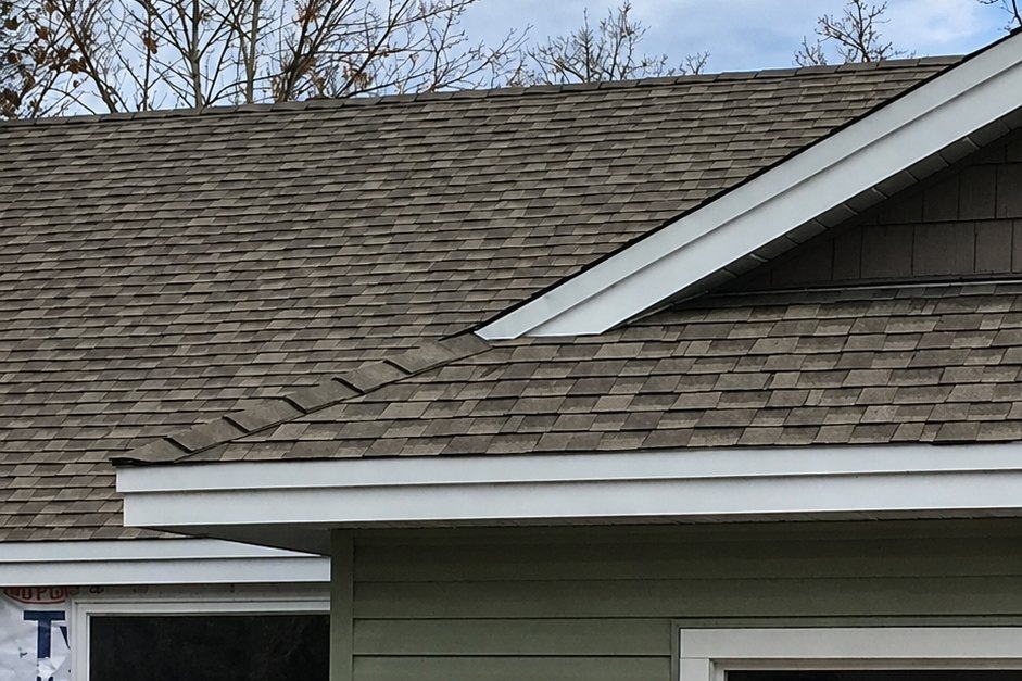 Roof corner where new siding meets the gutter line