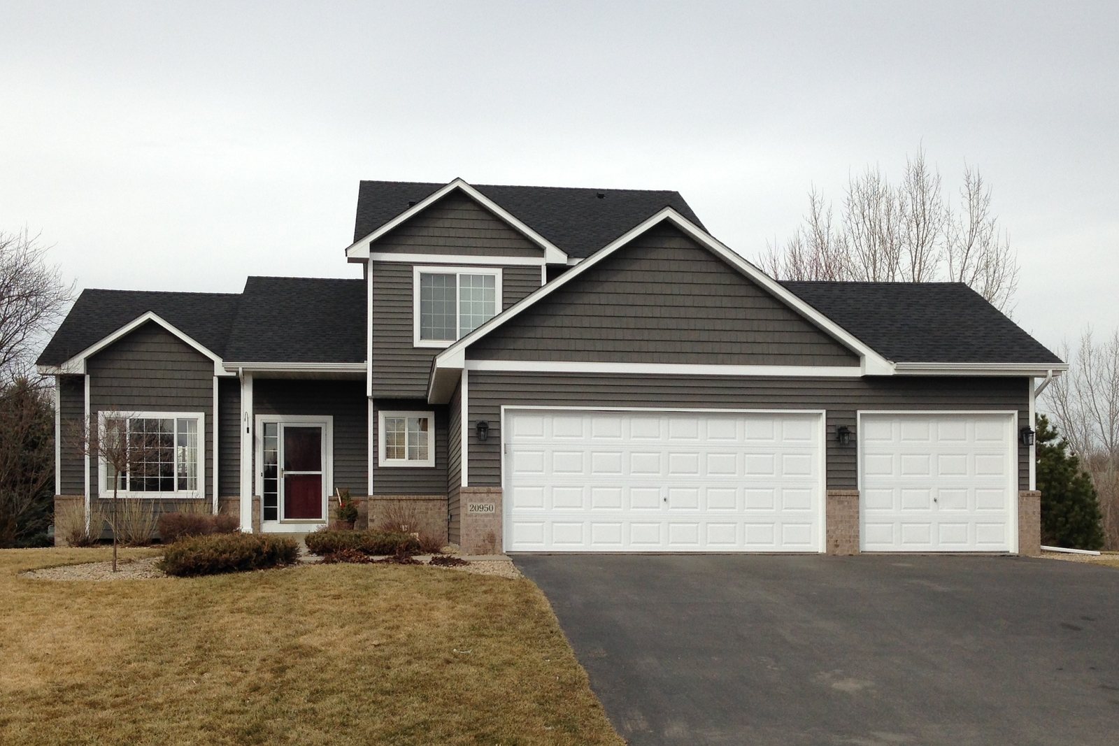 Shake-style gables above lap siding on a gray two-story home