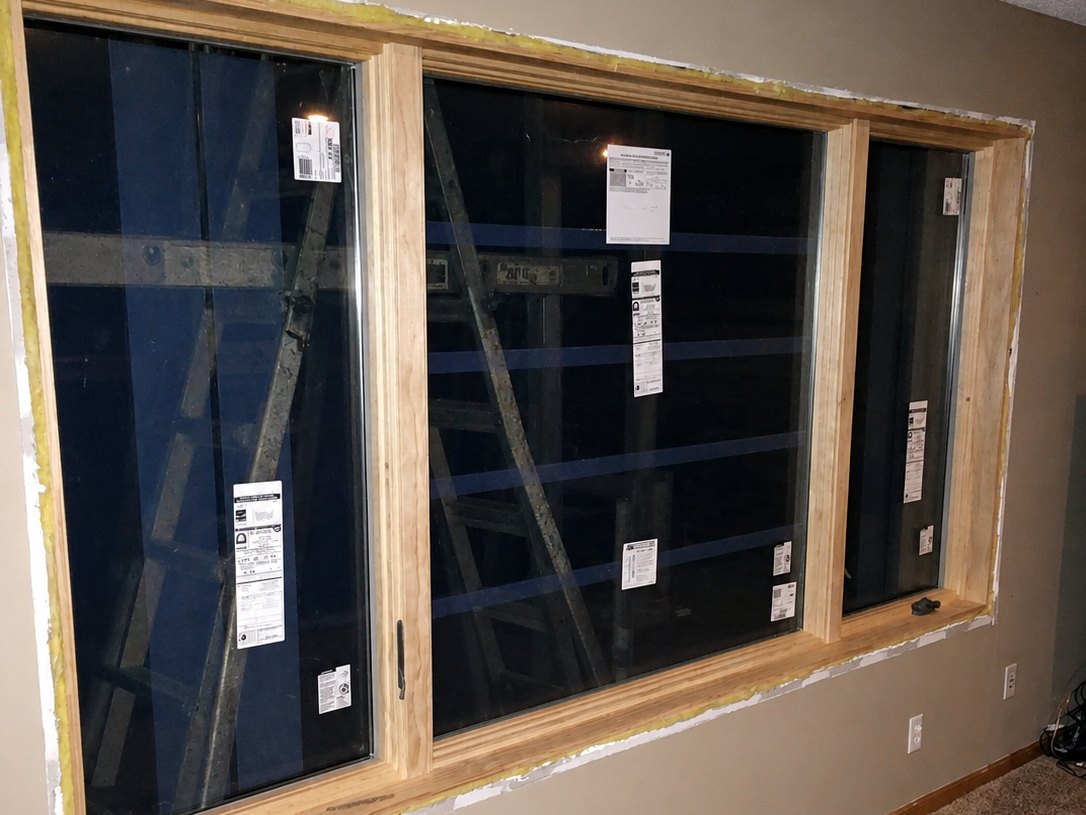 New slider windows set in a bare opening, factory labels still on the glass